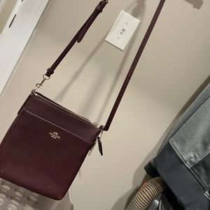 Coach ox blood purse with gold accents